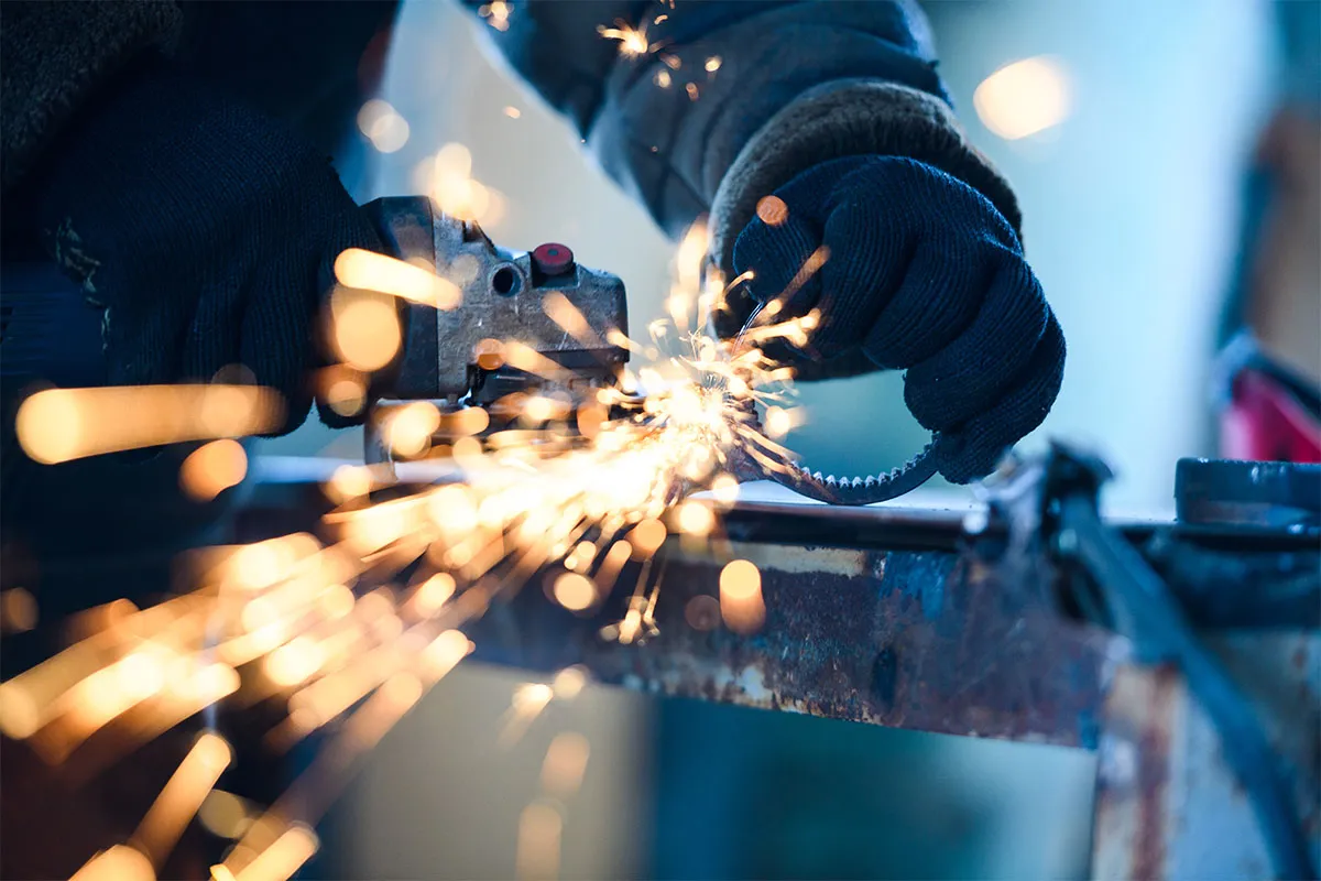 Angle grinder cutting steel, sparks flying