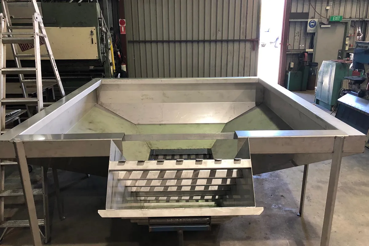 Stainless steel fish sorting table with a slatted chute